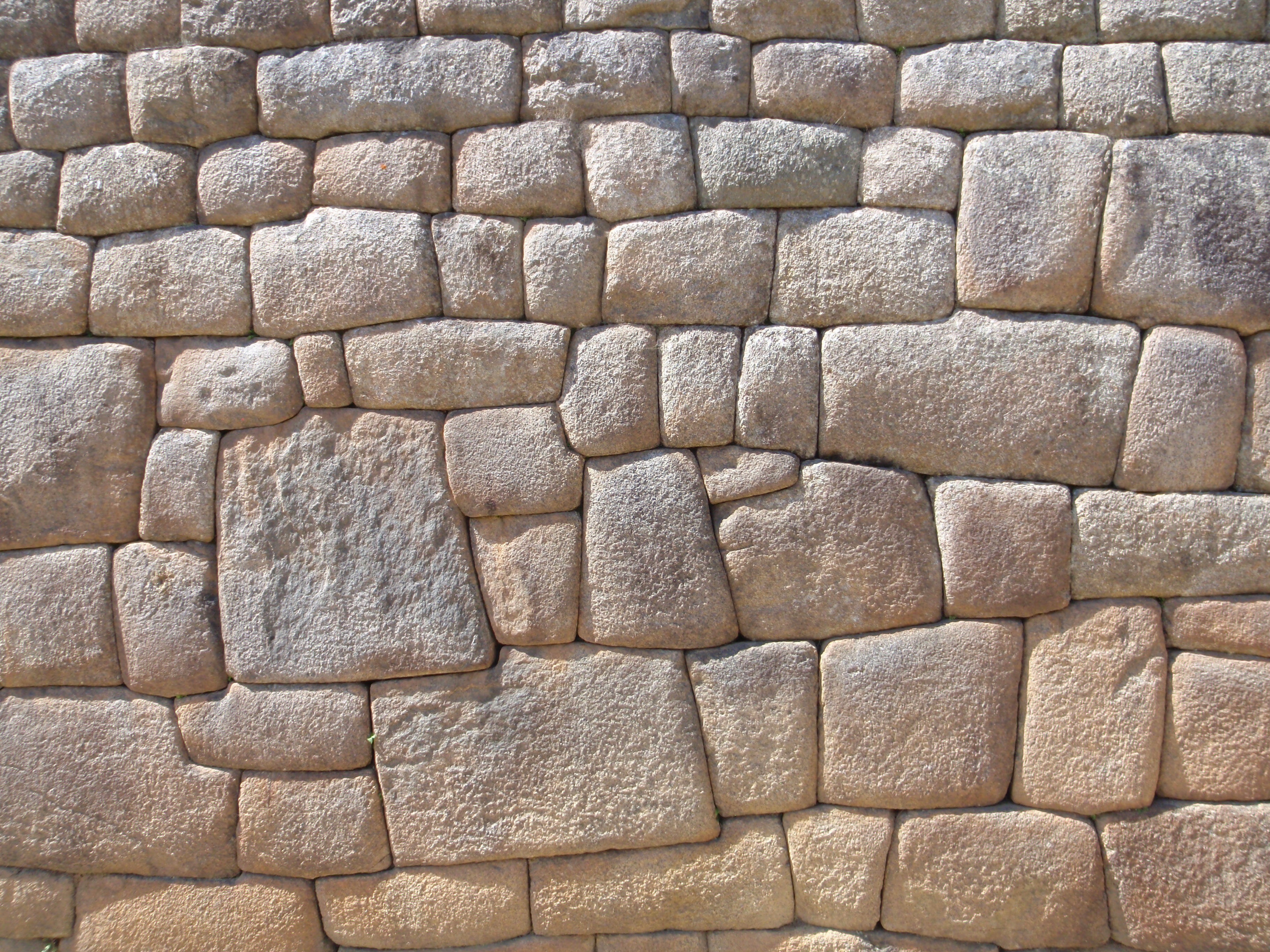 Detail image of stone masonry wall at Machu Picchu, Peru. Walls designed by the Incas were interlocked and are resistant to earthquakes due to the irregualr shapes and increased surface area of joints. Image search