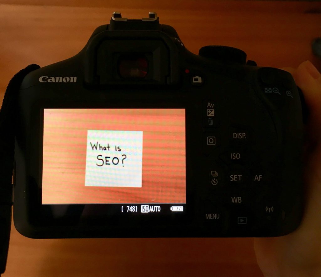 Camera with the intent to take a picture that focuses on the word SEO.